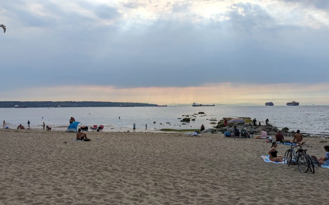people sitting and enjoying at third beach stanley park