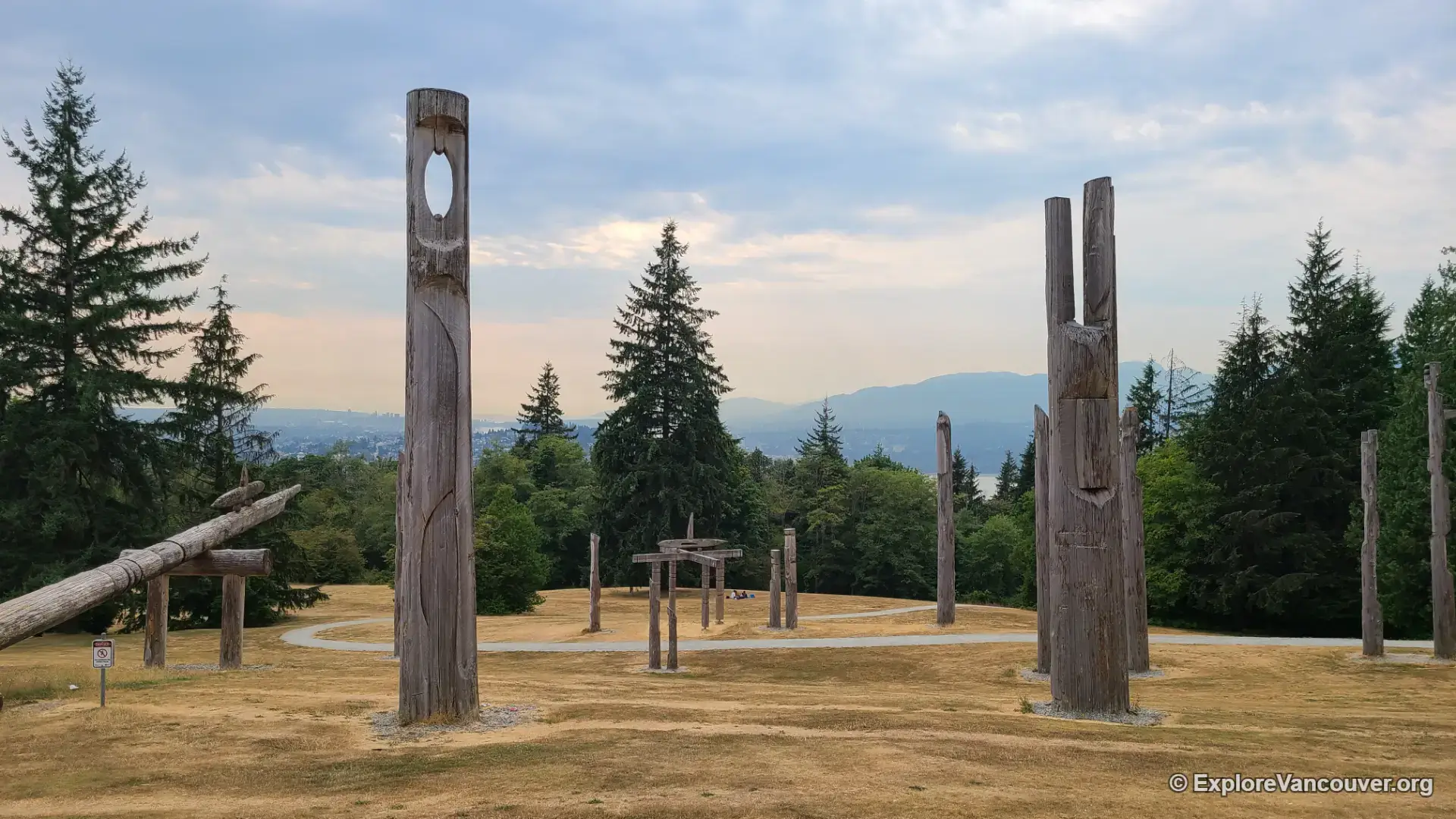 Close view of a totem pole sculpture at Kamui Mintara, Burnaby Mountain