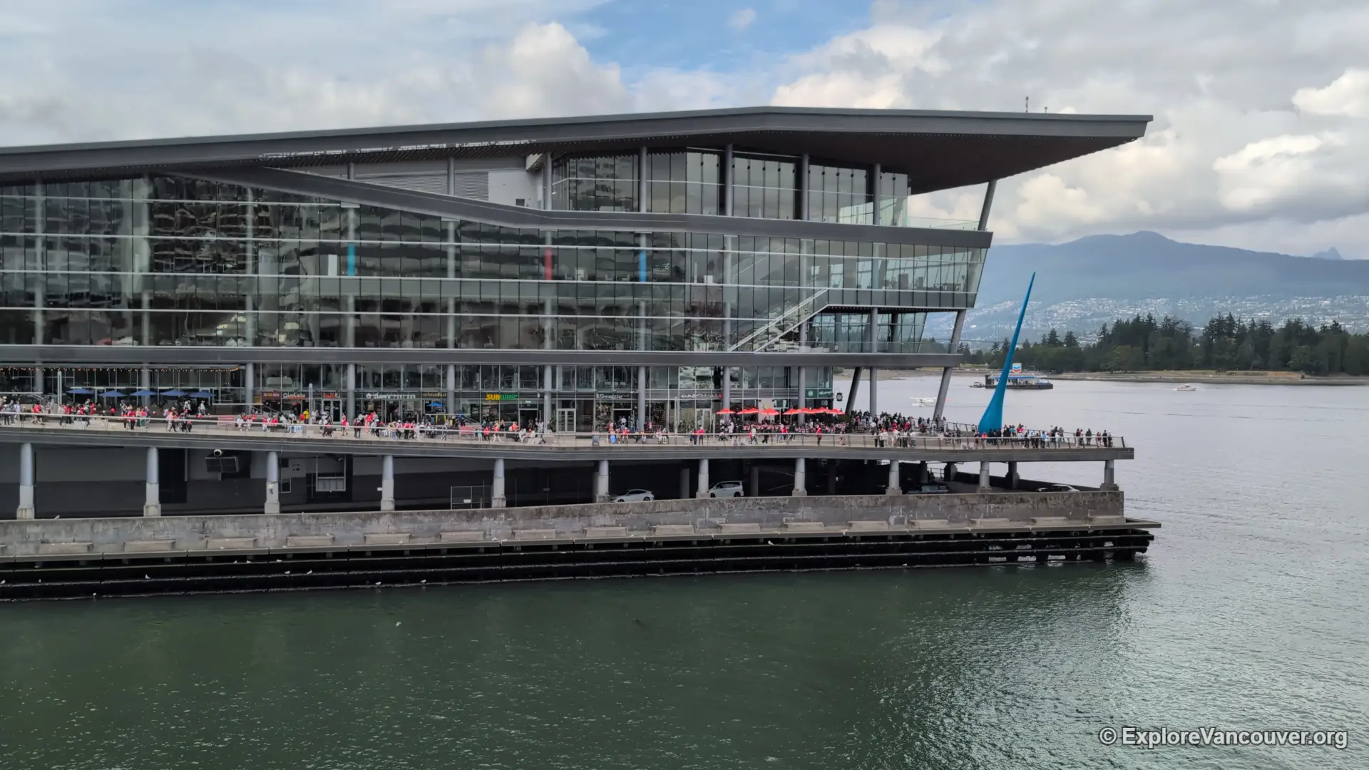 Overhead view of the plaza and walkways surrounding Canada Place, with downtown Vancouver streets in the background