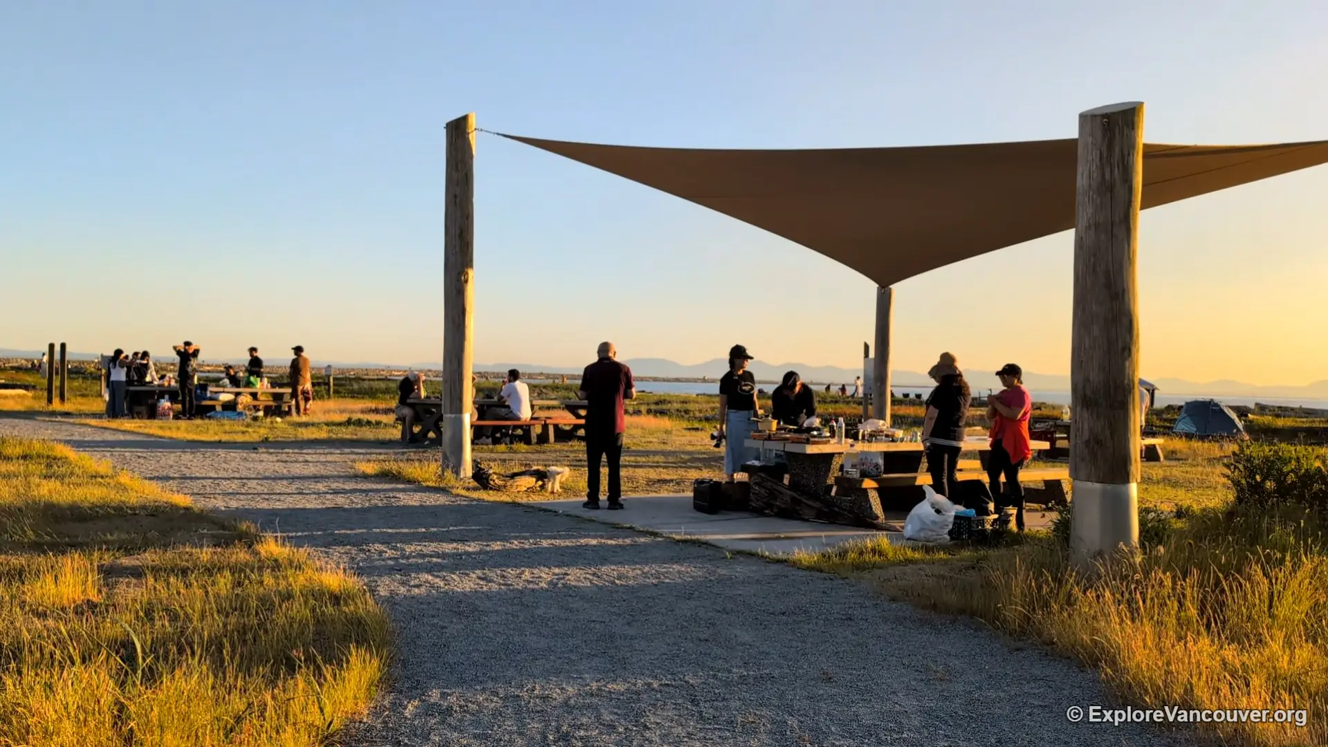 Visitors gathered on the sand at Iona Beach Regional Park