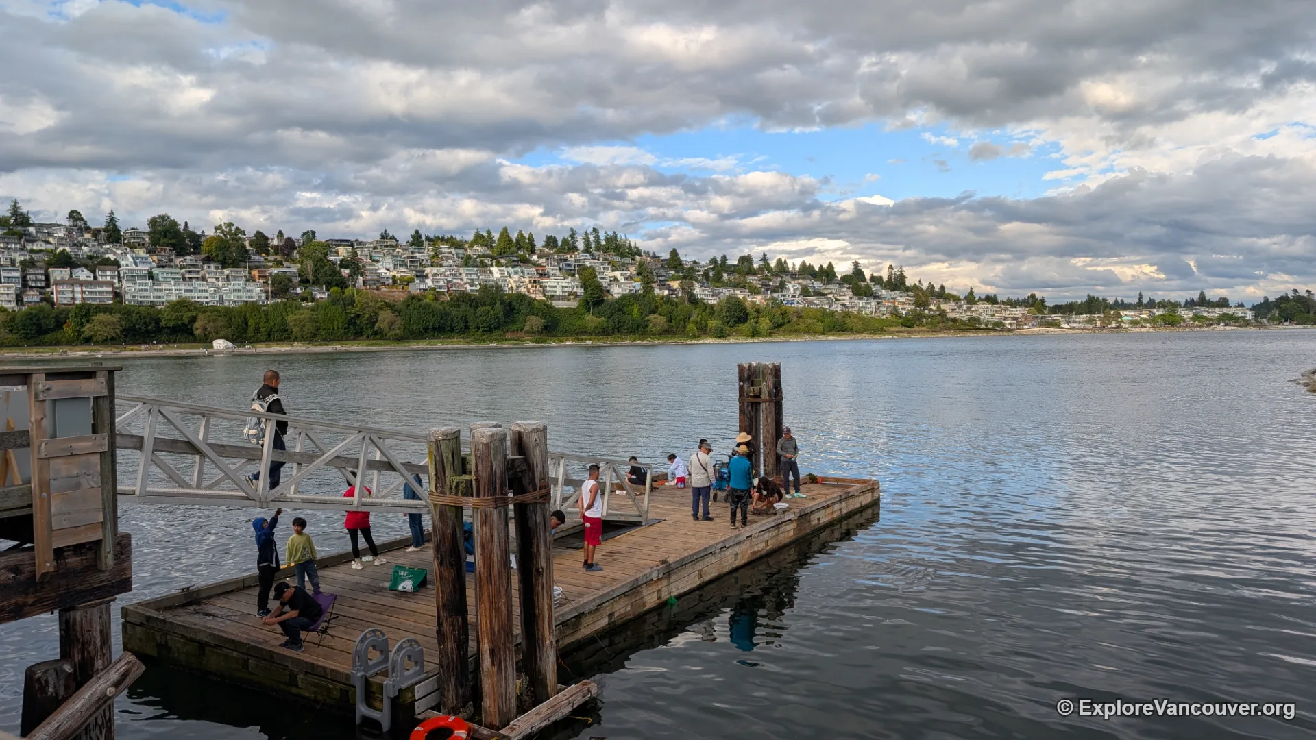 Anglers fishing from the rails of White Rock Pier over Semiahmoo Bay