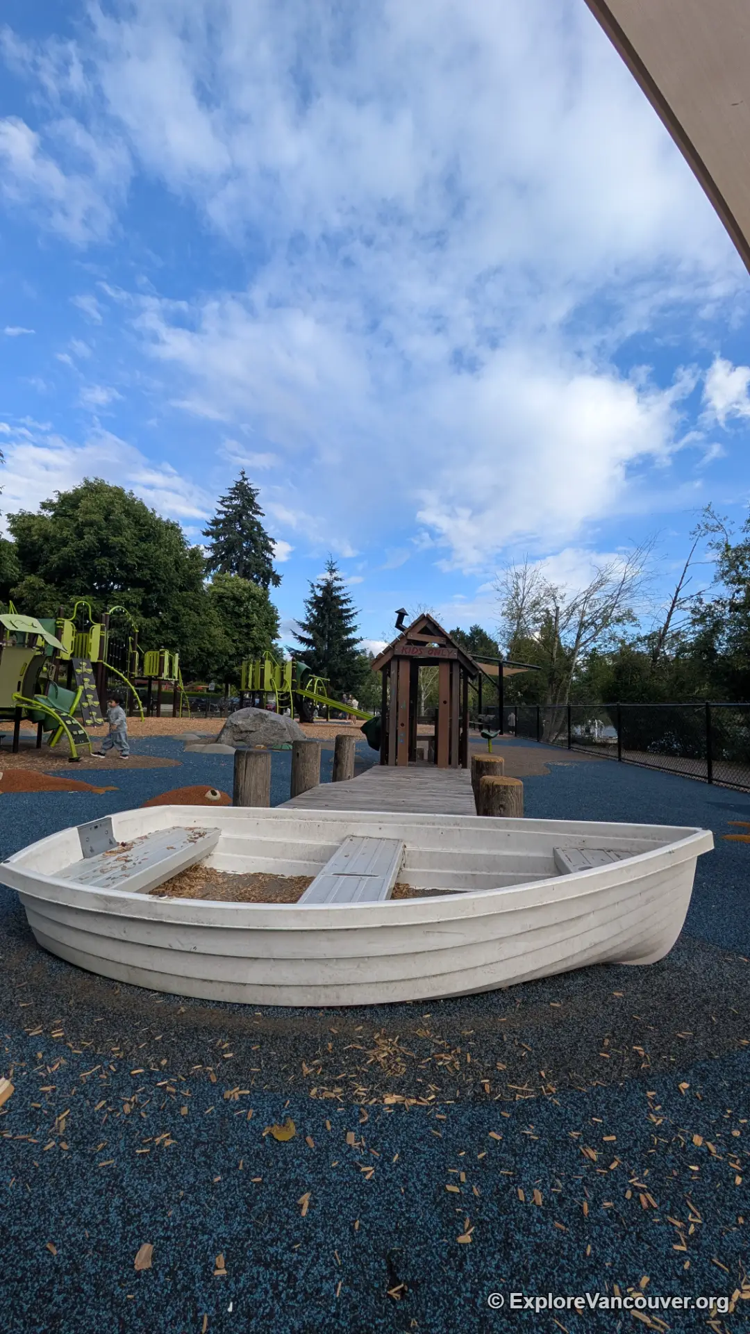 Vertical photo of the Como Lake Park playground surrounded by trees