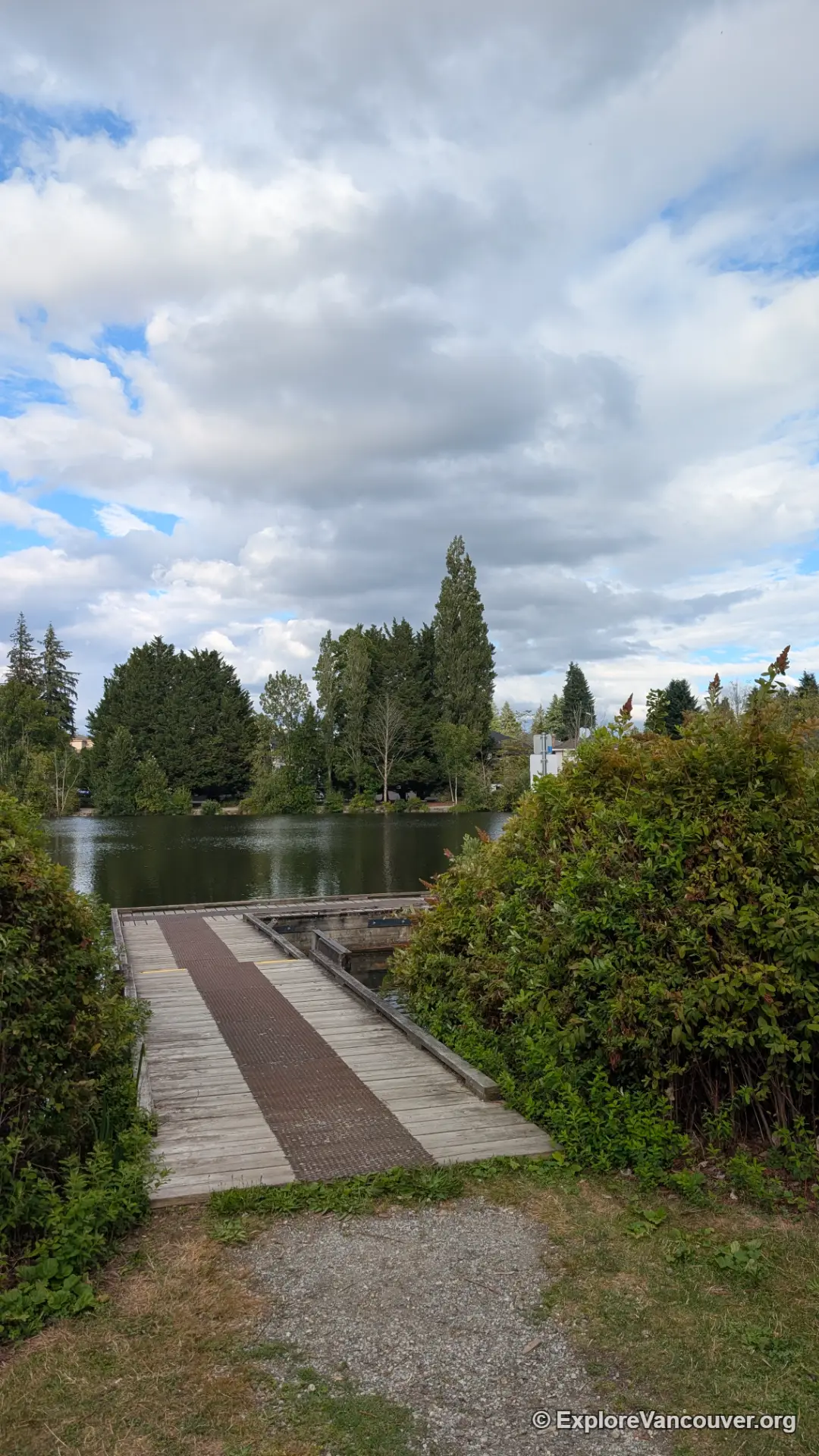 Wooden fishing dock and pier extending into Como Lake Coquitlam