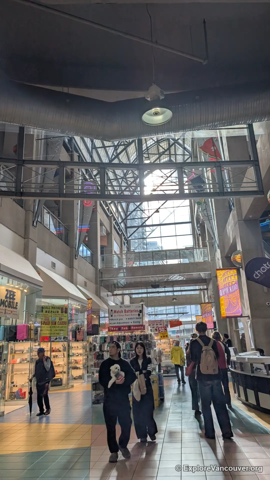 People walking through International Village Mall in Vancouver